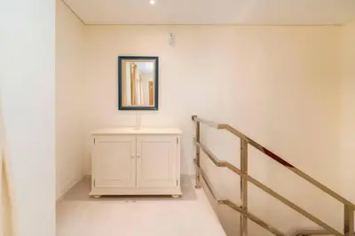 a hallway with a staircase and a mirror on the wall at 3 Quartos, Piscina, AC, Garagem, Prestige For Home in Faro