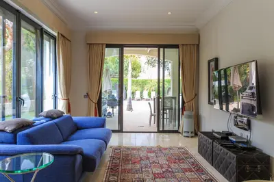 a living room with a blue couch and a sliding glass door at Villa Flow