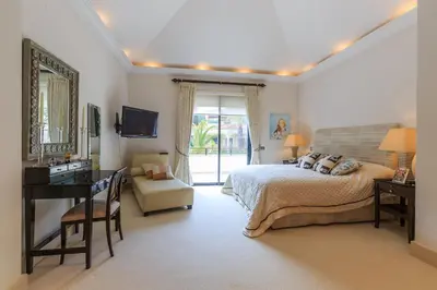 a bedroom with a bed and a desk and a television at Villa Flow