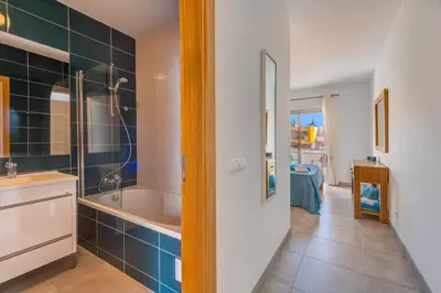 a bathroom with a tub and a sink and a shower at Apartamento Vista Piscina in Guia