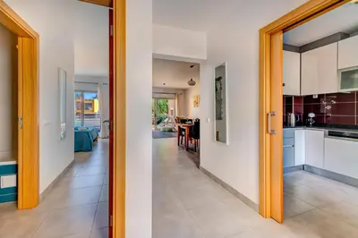 a kitchen and dining room with a view of a living room at Apartamento Vista Piscina in Guia