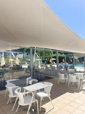 a group of tables and chairs under a white tent at Luxury Apartment in Vila Sol Resort in Quarteira
