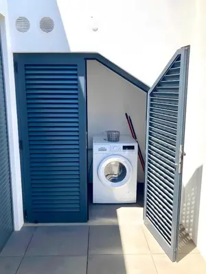 a laundry room with a washing machine and a washer at Villa Soligolf - Vilamoura, Algarve in Quarteira