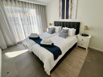 a bedroom with a large bed with two towels on it at Villa Soligolf - Vilamoura, Algarve in Quarteira