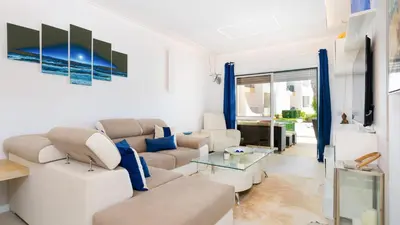 a living room with a couch and a table at Lounge Garden Apartment in Vilamoura