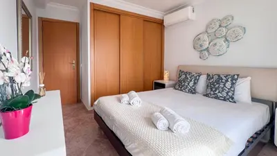 a bedroom with a bed with towels on it at Ocean View Quarteira in Quarteira