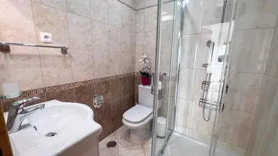 a bathroom with a shower and a toilet and a sink at Ocean View Quarteira in Quarteira