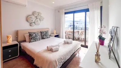 a bedroom with a bed with towels on it at Ocean View Quarteira in Quarteira