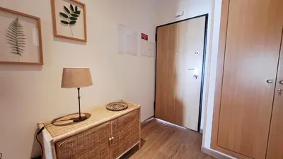 a room with a table with a lamp and a door at Jardins da Marina BQ in Albufeira
