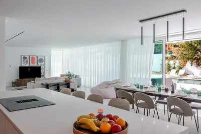 a living room with a couch and a flat screen tv at Modern 4-Bedroom Villa with Infinity Pool in Albufeira