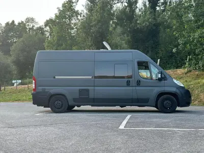 a blue van parked in a parking lot at Tiny House na Praia de Faro Experiencia Glamping in Faro