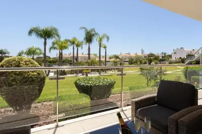 a balcony with a view of a park with palm trees at Snazzy Varandas do Castelo One Bedroom Apartment sleeps 2 persons in Albufeira