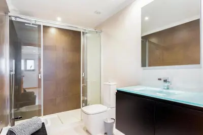 a bathroom with a shower and a toilet and a sink at Snazzy Varandas do Castelo One Bedroom Apartment with Sea View sleeps 2 in Albufeira
