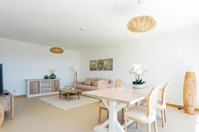 a living room with a table and a couch at Snazzy Varandas do Castelo One Bedroom Apartment with Sea View sleeps 2 in Albufeira