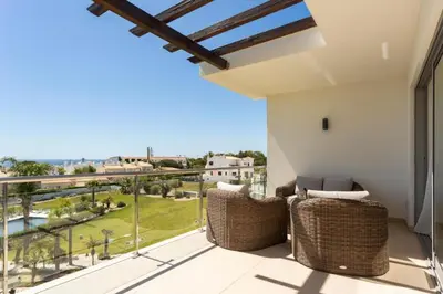 a balcony with wicker chairs and a view of the ocean at Snazzy Varandas do Castelo One Bedroom Apartment with Sea View sleeps 2 in Albufeira