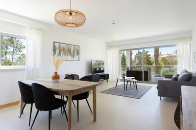 a living room with a wooden table and chairs at Snazzy Varandas do Castelo By Garvetur One Bedroom Apartment sleeps 2 persons in Albufeira