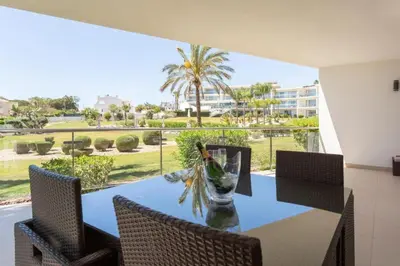 a dining room with a table and chairs and a view at Snazzy Varandas do Castelo By Garvetur One Bedroom Apartment sleeps 2 persons in Albufeira
