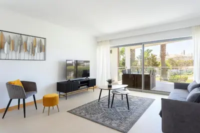 a living room with a couch and a table at Snazzy Varandas do Castelo - One Bedroom Apartment sleeps 2 person in Albufeira