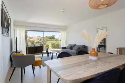 a living room with a table and a couch at Snazzy Varandas do Castelo One-Bedroom Apartment sleeps 2 person in Albufeira