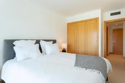 a bedroom with a large white bed with white pillows at Snazzy Varandas do Castelo One-Bedroom Apartment sleeps 2 person in Albufeira