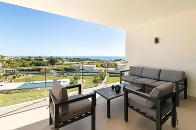 a living room with a couch and a table and a balcony at Snazzy Varandas do Castelo One Bedroom Apartment with Sea View sleeps 2persons in Albufeira
