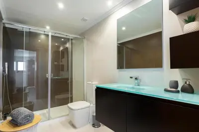 a bathroom with a shower and a toilet and a sink at Snazzy Varandas do Castelo One Bedroom Apartment with Sea View sleeps 2persons in Albufeira