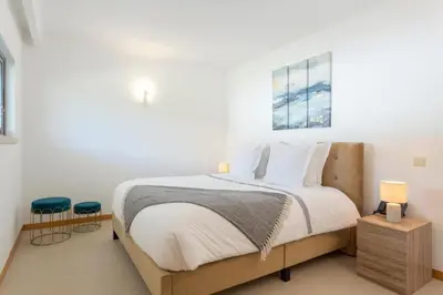 a bedroom with a bed with white walls and a window at Snazzy Varandas do Castelo One Bedroom Apartment with Sea View sleeps 2persons in Albufeira