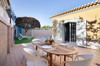 a patio with a table and chairs on it at Casa da Várzea in Albufeira