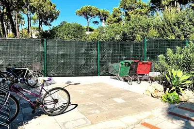 a bike parked next to a fence with a shopping cart at Villa With BBQ and Pool in Vilamoura in Quarteira