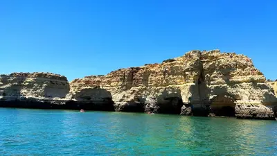 a view of the water in front of a rocky cliff at Villa With BBQ and Pool in Vilamoura in Quarteira