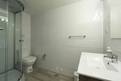 a bathroom with a toilet and a glass shower at Vila Popa - Golf Front with Games Room by HD in Vilamoura