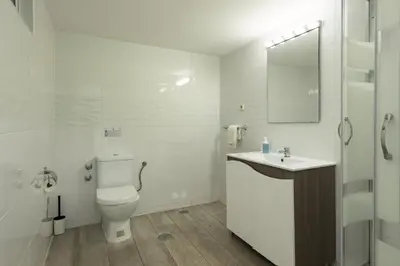 a bathroom with a toilet and a sink and a mirror at Vila Popa - Golf Front with Games Room by HD in Vilamoura