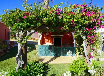 a house with pink flowers on top of it at Vila Luz in Vilamoura