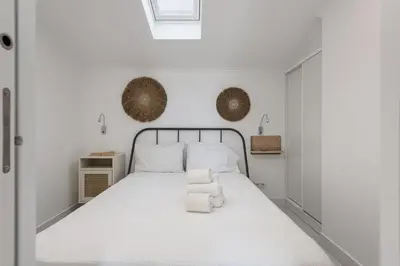 a bedroom with a large white bed with white sheets at Marina Praia - Marina view by HD in Vilamoura