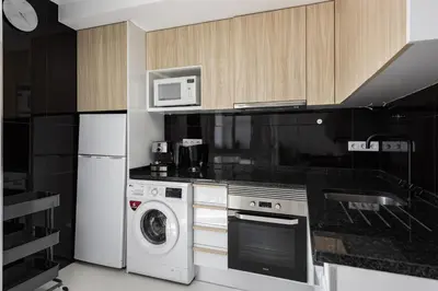 a kitchen with a washing machine and a microwave at Marina Praia - Marina view by HD in Vilamoura