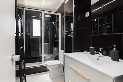 a bathroom with a toilet and a glass shower at Marina Praia - Marina view by HD in Vilamoura