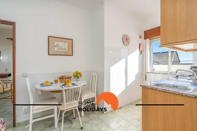 a small kitchen with a table and a sink at #352 Travessa do Mar Flats by Home Holidays in Albufeira