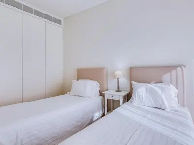 two beds sitting next to each other in a bedroom at 2bdr Horizon Sand apartment in Quarteira in Quarteira