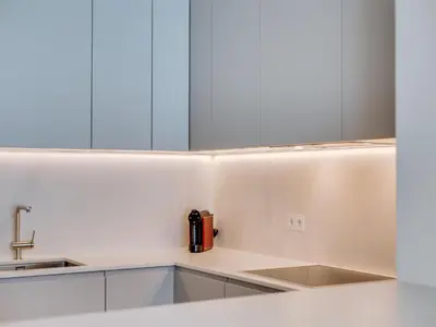 a kitchen with white cabinets and a sink at 2bdr Horizon Sand apartment in Quarteira in Quarteira
