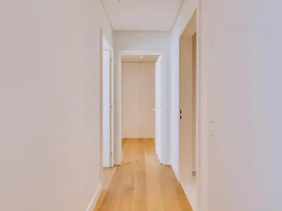 an empty hallway with white walls and wood floors at 2bdr Horizon Sand apartment in Quarteira in Quarteira