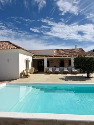 a swimming pool in front of a house at Casa Oliva do Sul in Almancil