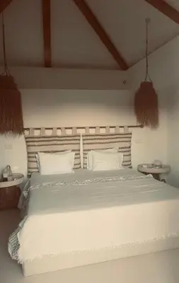 a bedroom with a large white bed with white pillows at Casa Oliva do Sul in Almancil