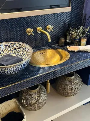 a bathroom with a sink and bowls on a shelf at Casa Oliva do Sul in Almancil