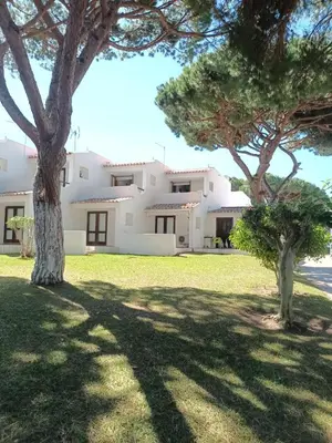 a large white house with trees in front of it at Studio Açoteias 410 in Albufeira