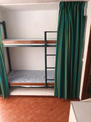 a room with two bunk beds with green curtains at Studio Açoteias 410 in Albufeira