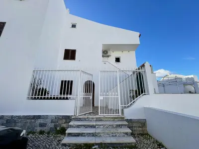 a white house with stairs leading up to it at Albufeira Shine by Homing in Albufeira