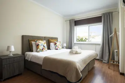 a bedroom with a large bed and a window at Vilamoura fresh by Hd in Vilamoura