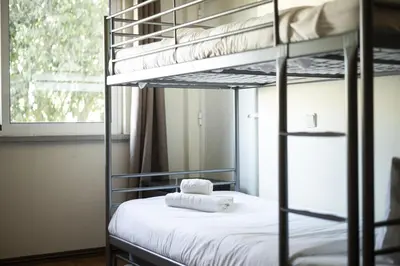 a bedroom with a bunk bed with white sheets at Vilamoura fresh by Hd in Vilamoura