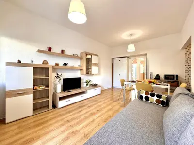 a living room with a couch and a television at Vilamoura Downtown by Homing in Vilamoura