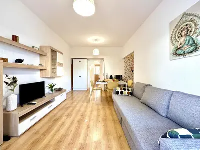 a living room with a couch and a tv at Vilamoura Downtown by Homing in Vilamoura